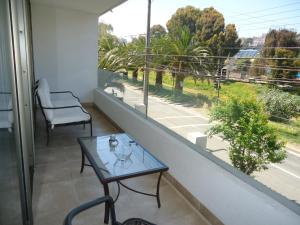 d'un balcon avec une table, une chaise et une fenêtre. dans l'établissement Departamento Reñaca Park, à Viña del Mar