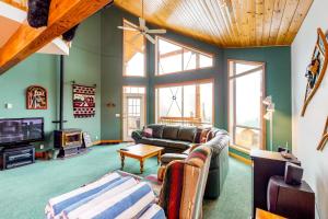 a living room with a couch and a tv at DuHaus Green in Big White