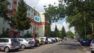 a row of cars parked on the side of a street at Ares Apartments in Przemyśl