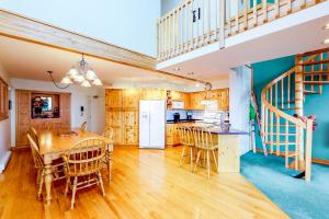 a kitchen with wooden cabinets and a table and chairs at DuHaus Green in Big White