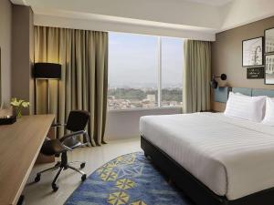 Voodi või voodid majutusasutuse Mercure Bandung Nexa Supratman toas