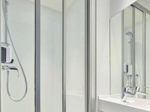 a bathroom with a shower and a sink at hotelF1 Paris Porte de Montreuil in Bagnolet