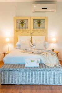 a bedroom with a large white bed with two lamps at Farm & Co-sy by Kingscliff Accommodation in Cudgen