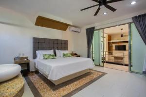 a bedroom with a large bed and a bathroom at Casa Kaoba Hotel & Suites in Playa del Carmen +45 photos