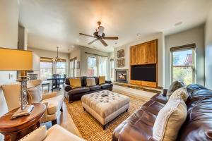 a living room with leather furniture and a flat screen tv at Lava Falls at Entrada & Santa Clara Sunrise in Santa Clara