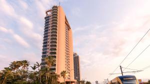 a tall building with a bus in front of it at Oaks Gold Coast Hotel in Gold Coast