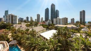 a city skyline with palm trees and buildings at Oaks Gold Coast Hotel in Gold Coast
