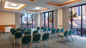 a conference room with chairs and tables and windows at Oaks Gold Coast Hotel in Gold Coast +47 photos