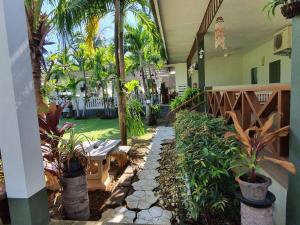 a courtyard with plants and a bench in a house at Happy Mind Resort in Sam Roi Yot