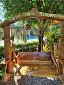a wooden bench with a happy third respect sign at Happy Mind Resort in Sam Roi Yot