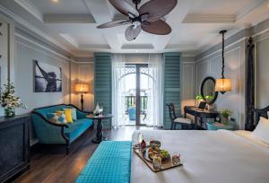 a room with a bed with a tray of food on it at Anio Boutique Hotel Hoian in Hoi An