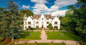 an aerial view of a large white house with a yard at Kincraig Castle Hotel in Invergordon