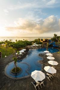 un complejo con una piscina con sombrillas y el océano en Grand Mirage Resort & Thalasso Bali - All Inclusive, en Nusa Dua