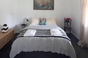 a bedroom with a large bed with two pillows at Domino House in Trentham