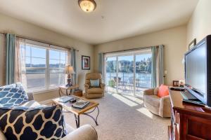 a living room with a flat screen tv and a large window at River Vista in Florence