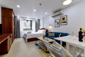 a hotel room with a bed and a dining room at Woody House Saigon Center in Ho Chi Minh City