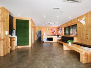 a living room with wooden walls and a green wall at RS Boutique Hotel in Kluang