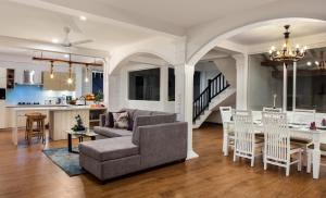 a living room and kitchen with a couch and a table at Villa Mer Vue in Ambalangoda