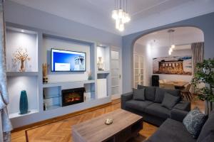 een woonkamer met een bank en een open haard bij Blue Ark Lavish Sauna Suite in Athene