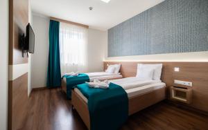 Posteľ alebo postele v izbe v ubytovaní Hotel Szeghalom