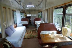 vagone ferroviario con un letto e un tavolo di Yamba Hinterland bush retreat - Vintage bus stay a Dilkoon Altre 22 foto