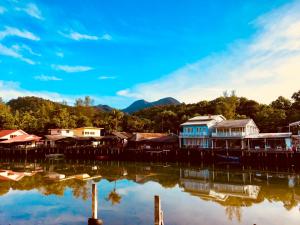 a group of houses on a dock on a body of water at Watercolours in Ko Chang