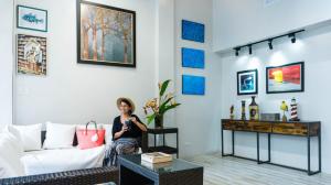 a woman sitting on a couch in a living room at South Anchorage Inn in El Nido