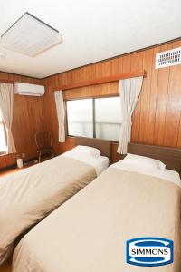 Postel nebo postele na pokoji v ubytování LAZYHOUSE 別邸