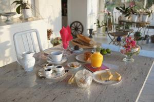 a table topped with plates of food and orange juice at Les Raisins du Bonheur in Puisseguin
