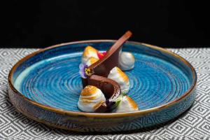 a blue plate with food on a table at Labirint Boutique Hotel - Central Location in Bucharest +42 photos