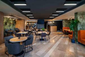 a restaurant with tables and chairs in a room at Labirint Boutique Hotel in Bucharest