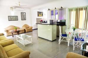 a living room with a couch and a table at Villa Samaara14 Candolim Beach 500mts in Candolim