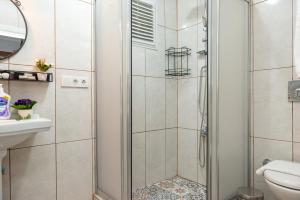 a shower with a glass door in a bathroom at Dualis Hotel in Istanbul