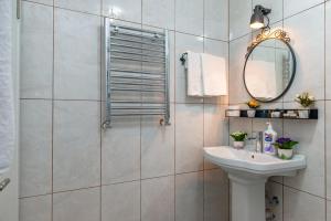 a bathroom with a sink and a shower with a mirror at Dualis Hotel in Istanbul