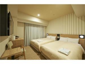 Sotetsu Fresa Inn Kamakura-Ofuna Higashiguchi客房内的一张或多张床位