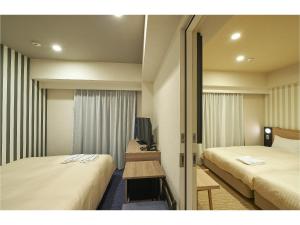 Postel nebo postele na pokoji v ubytování Sotetsu Fresa Inn Kamakura-Ofuna Higashiguchi