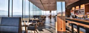 a restaurant with a bar with a view at COOL MAMA Hotel Salzburg in Salzburg
