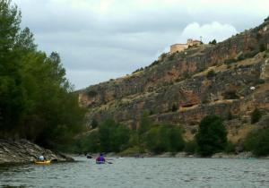 a group of people kayaking on a river with a mountain at Casa Rural Inma, Segovia ,Hoces del Duraton y cerca de Madrid in Muñoveros