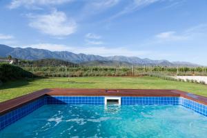 a swimming pool with a view of the mountains at Cellar1947 in Robertson