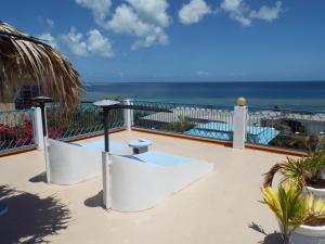 a balcony with a view of the ocean at Le Paradiso Apartments in Rodrigues Island