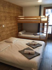 two bunk beds in a room with towels on them at Les Carlines in Vars