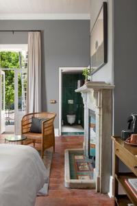 a bedroom with a bed and a fireplace at Harpers House in Cape Town +68 photos