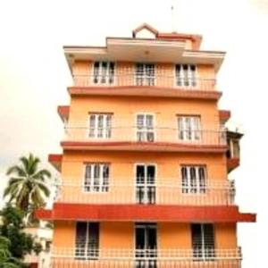 a tall orange building with a lot of windows at V bee Plaza in Trivandrum