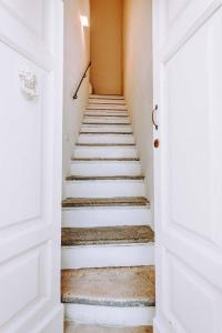 a stairway with white walls and white doors at Dimora Anderì in Polignano a Mare