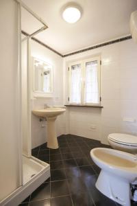 a bathroom with two toilets and a sink at Casa Giulia - HelloElba in Marina di Campo