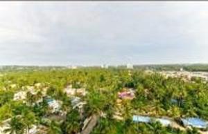 an aerial view of a resort with trees and water at V bee Plaza in Trivandrum