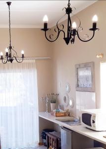 a kitchen with a chandelier hanging from the ceiling at Starry Nights in Middelburg