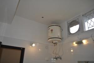 a bathroom with a hair dryer hanging from a ceiling at Hotel Maha Luxmi Palace in Katra +34 photos