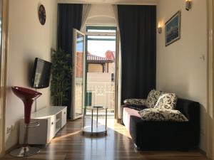 a living room with a couch and a window at Apartment Central Old town in Split