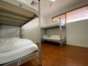 a room with two bunk beds and a window at Downtown Backpackers Hostel Perth - note - Valid Passport required for check in in Perth